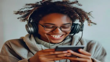 a person listening to music on their phone with a happy expression