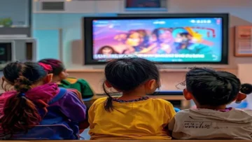 Children watching a colorful animated music video of Tayr Al-Jannah songs on a TV screen i